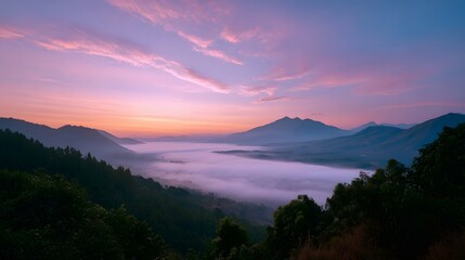 Obraz premium A breathtaking panoramic view of mountains emerging from a dense layer of mist under a pastel sunrise sky