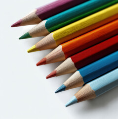 Fototapeta premium Colored pencils arranged diagonally on white background, vibrant hues, art supplies, creative, close up, sharp tips, school material