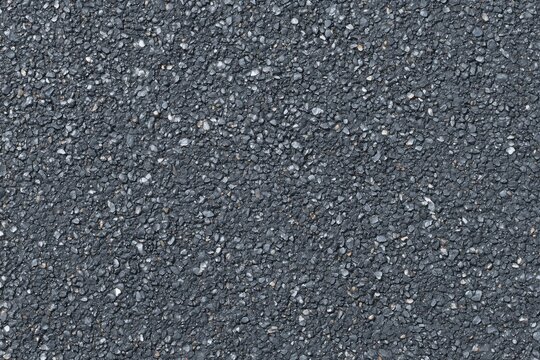 Close-up of textured asphalt surface with small gravel pebbles