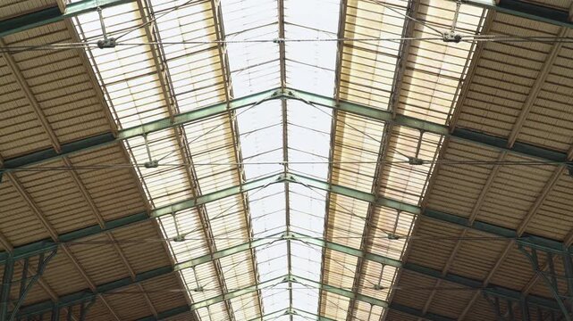 Architectural interior view on iron and glass arched ceiling at Gare du Nord station, Paris, France.