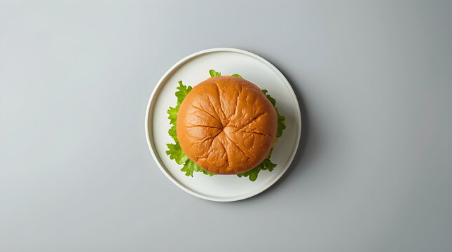 Flat Lay of a Simple Burger Bun and Green Lettuce on Grey Background