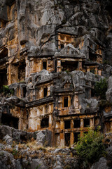 Fototapeta premium Ancient Rock-Cut Tombs Carved into a Steep Limestone Cliff