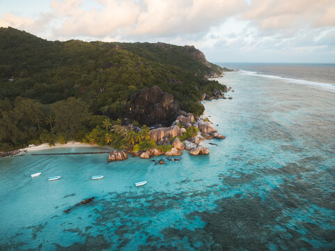 Aerial view of Anse Source d'Argent beach featuring turquoise waters, granite rock formations, and lush tropical vegetation in L'Union Estate, Seychelles.