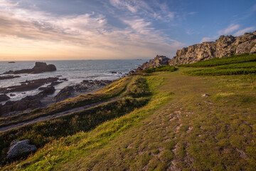 Scenic coastal landscape of Guernsey with lush greeney overlooking turquoise Atlantic ocean. © Tadeas