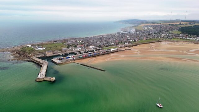 Aerial approach from the sea toward Burghead harbour and town, Moray Firth, Scotland
