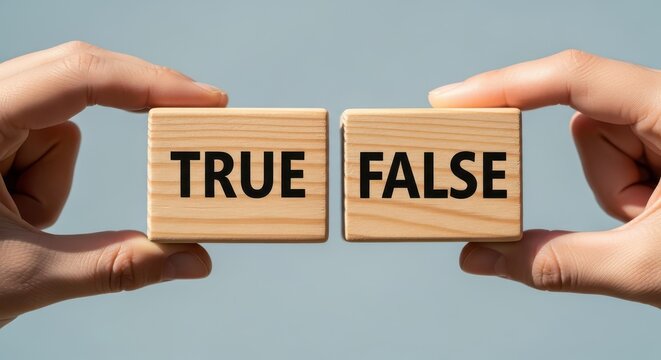 Hands hold wooden blocks displaying the words true and false representing a choice or dichotomy.