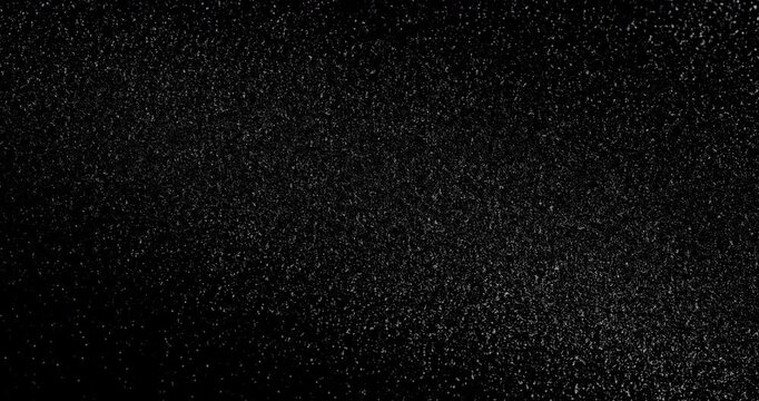 Abstract black texture. The slow, smooth diagonal movement of a dark, rough surface moving in a soft beam of light.