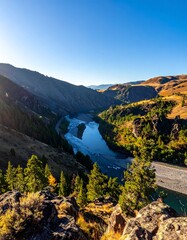Naklejka premium Serene River Winding Through Mountains.