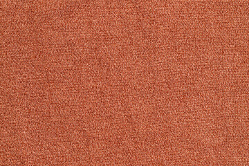 Fototapeta premium Fabric texture in orange color used for clothing or decoration in a bright setting