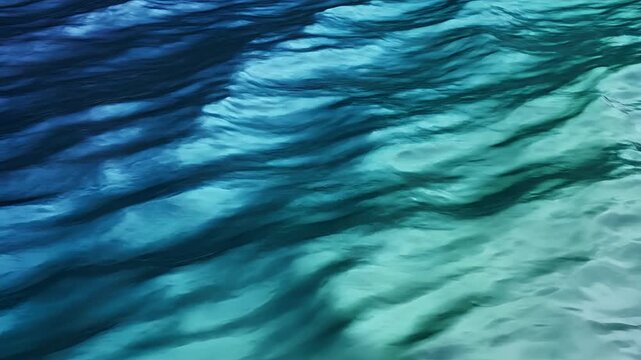 Abstract Rippling Water Surface with Blue and Teal Hues.