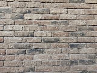 Fototapeta premium Texture of old brown brick wall with rough surface and weathered bricks