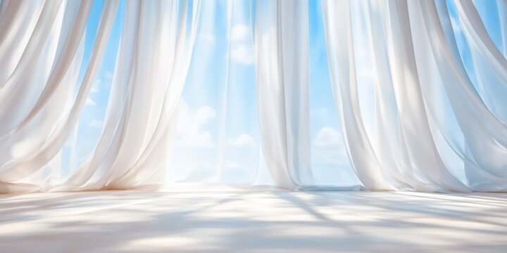 White curtains blowing in the breeze against a bright blue sky