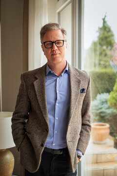 Portrait of a confident middle-aged man by the window