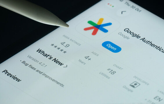 Dhaka, Bangladesh- 30 Oct 2025: Google Authenticator app on a iPad screen with a pen pointing at the install option.