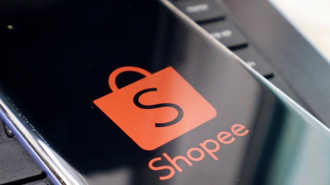 A close-up view of the Shopee logo on a laptop screen