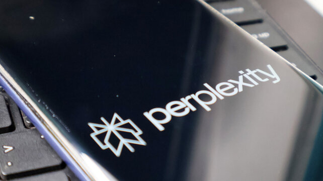 A close-up view of a laptop screen displaying the Perplexity logo on a keyboard