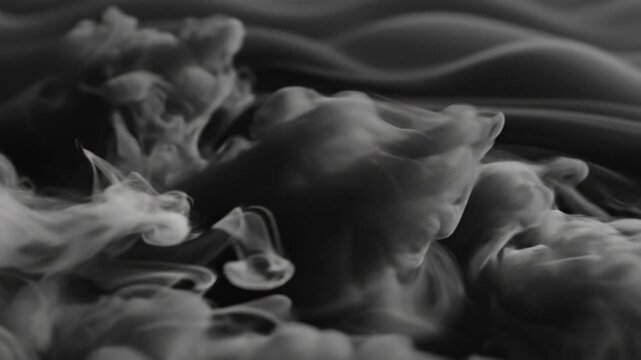 Smoke swirling in dark space.