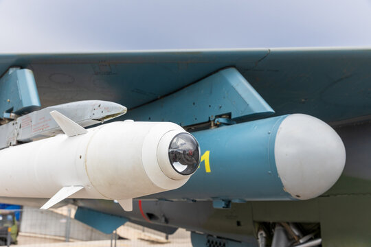 Air to surface guided missile with TV optical guidance sensor under fighter jet wing close up