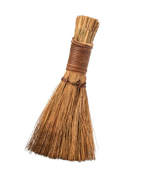 A small handmade rustic straw whisk broom isolated on a transparent background. Traditional natural fiber tool that can be used for light cleaning or as decorative rustic home decor.