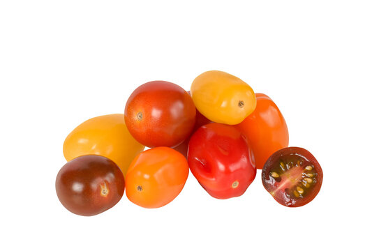 Heap of assorted mini grape and cherry tomatoes in various colors isolated cutout on transparent background. Fresh produce composition ideal for food design, mockup, and compositing use.