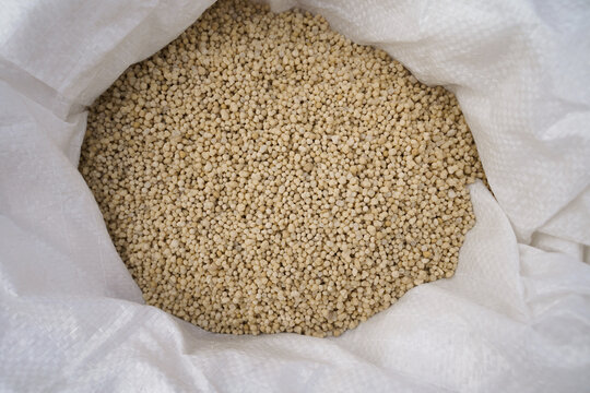 Ammonium nitrate in a bag. Nitrogen fertilizer for feeding plants after winter.