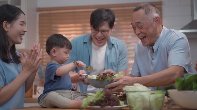 Happy multigenerational family preparing healthy meal together in kitchen, parents and grandfather bonding with child, fresh food and warm lifestyle concept