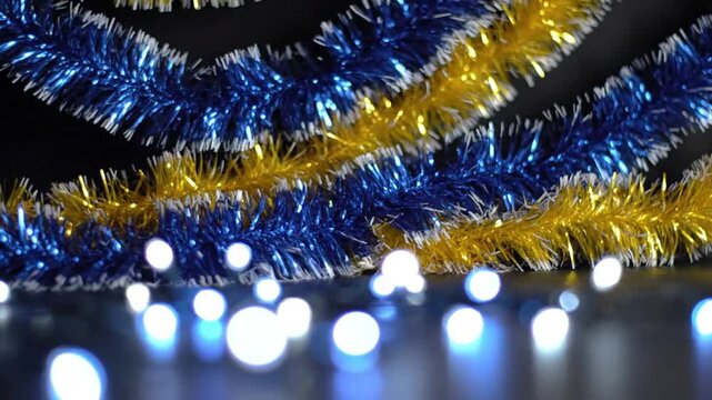 Festive blue and gold tinsel garlands with twinkling fairy lights creating a holiday atmosphere
