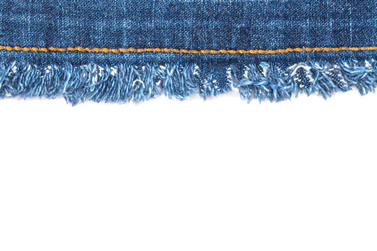 Denim fabric with frayed edge shows the texture and detail of a casual wear item suitable for many outfits and styles