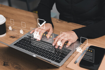 Real estate comparison concept. Professional using laptop to review home listings, ratings and...