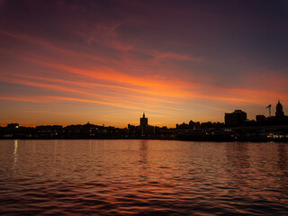 Naklejka premium Malaga city skyline at vivid twilight sunset