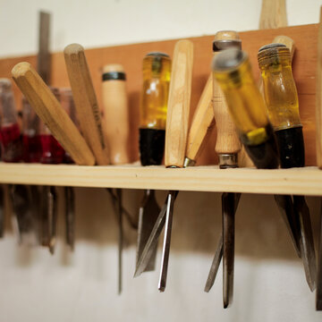 Woodworking tools hanging on workshop rack