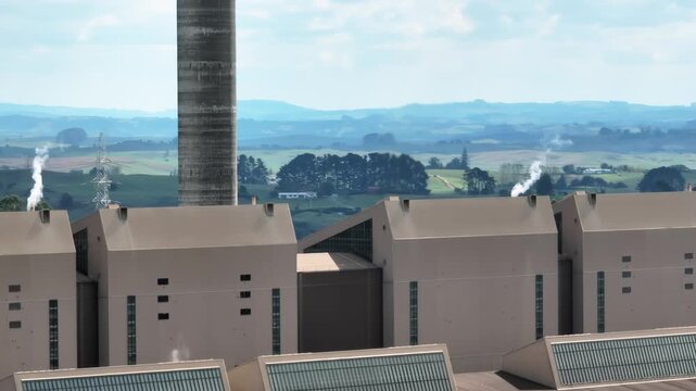 Steam rises from Huntly Powerstation, Huntly, Waikato, New Zealand. This plant harnesses the Earth's natural heat for sustainable energy.