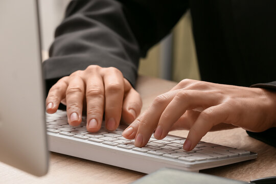 Young female programmer working with computer in office, closeup
