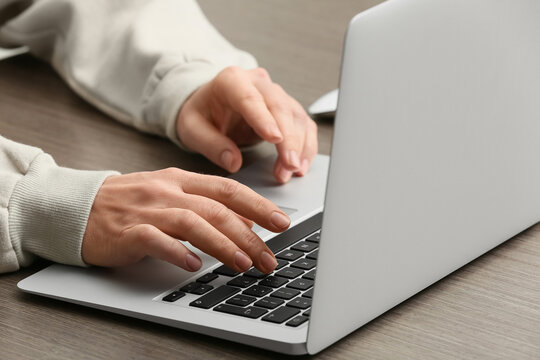Young female programmer working with laptop in office, closeup