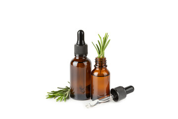 Fototapeta premium Rosemary essential oil isolated on a white background. Rosemary essential oil with fresh leaves nearby. Green rosemary sprig. Natural medicine, organic hair product, skin care, spa therapy. Beauty 
