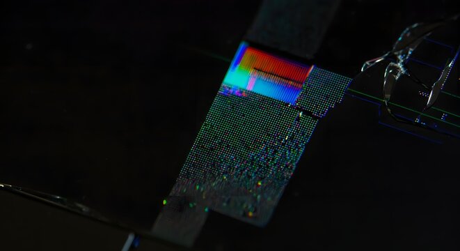 Close up cracked LCD laptop screen distorted RGB pixel bleeding.