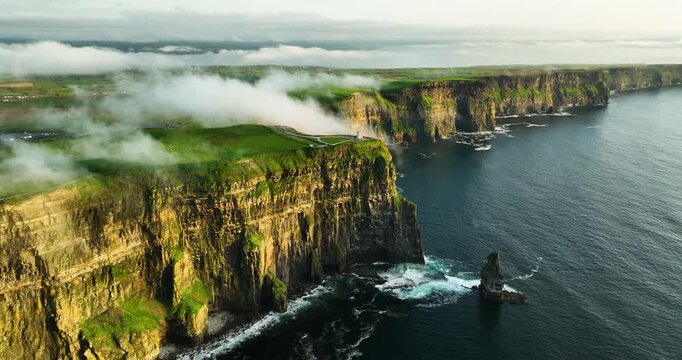 Cliffs of Moher and O Brien Tower at Sunrise, Aerial Drone Pullback Over Atlantic Coast, County Clare Ireland