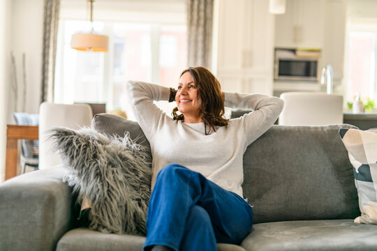 Beautiful aging. Portrait pretty mature female pensioner sit on sofa
