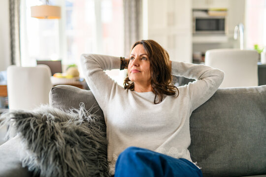Beautiful aging. Portrait pretty mature female pensioner sit on sofa