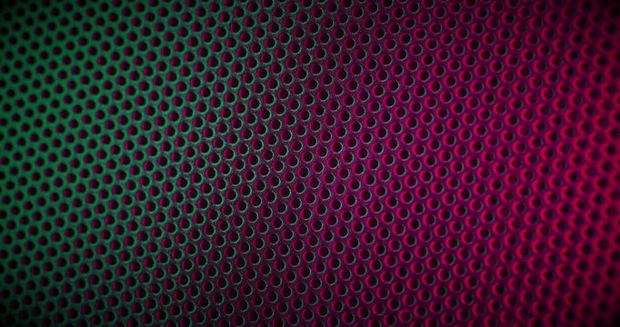 Close-up view of a color perforated surface with a repeating hole pattern, creating a textured and industrial look.