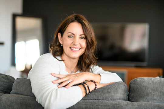 Beautiful aging. Portrait pretty mature female pensioner sit on sofa