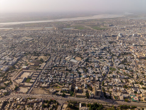 Aerial view of the dense urban landscape with sprawling residential buildings and the Indus River in the distance Hyderabad, Sindh, Pakistan.