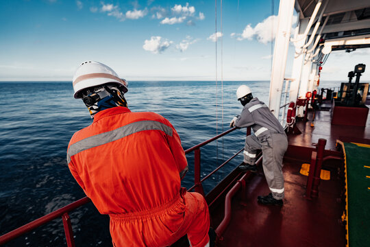 Offshore Deck Crew Performing Crane Operation on Supply Vessel at Sea