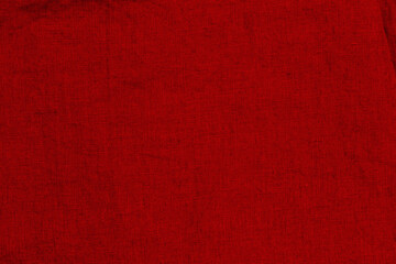 Fototapeta premium Bright red fabric close up shows texture and weave during daylight