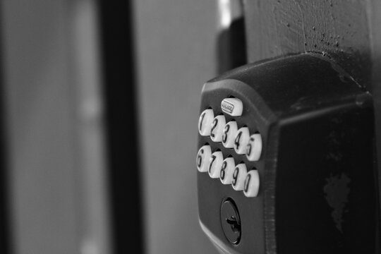 Close-up of residential keypad entry lock installed on exterior doorway in Corona, California representing modern home access control and neighborhood security infrastructure.