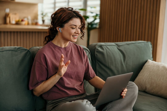 Woman smiling having video call with laptop