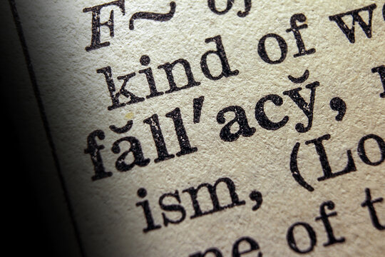 Word fallacy printed on dictionary page, macro close up