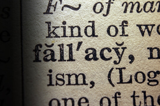 Word fallacy printed on dictionary page, macro close up