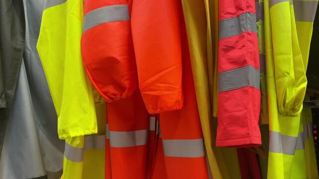 Close-up of high-visibility safety vests and workwear on shelves