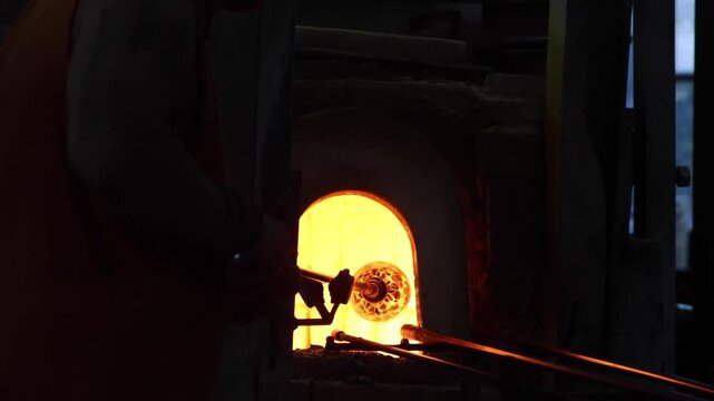 Murano, Venice, Italy, glassmaker working on handmade glass sculpture 